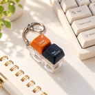 Enter Christ Escape Anxiety light-up keycap keychain styled beside a keyboard and notebook in warm natural light