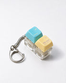 Enter His Rest double light-up keycap keychain with blue and yellow keys on a white background