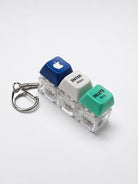 Enter Jesus Delete Sins triple light-up keycap keychain in blue, white and green on a white background