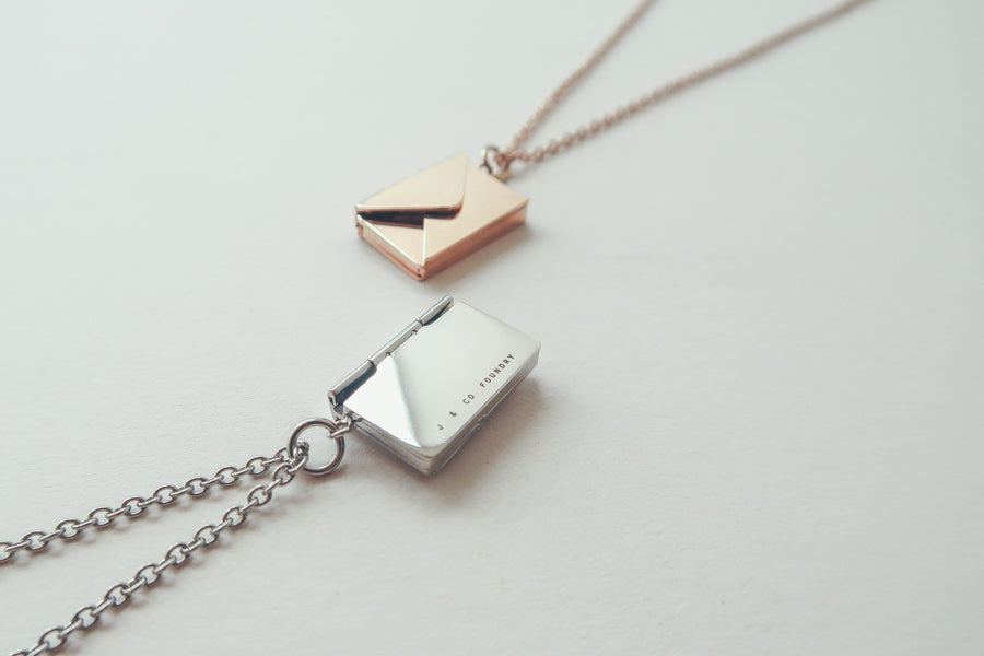 Envelope Locket personalised necklace by J&Co Foundry in a styled product view.