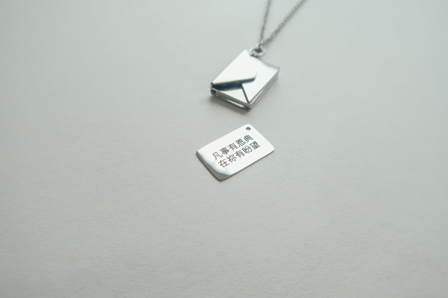 Personalised Envelope Locket necklace styled as a meaningful gift.
