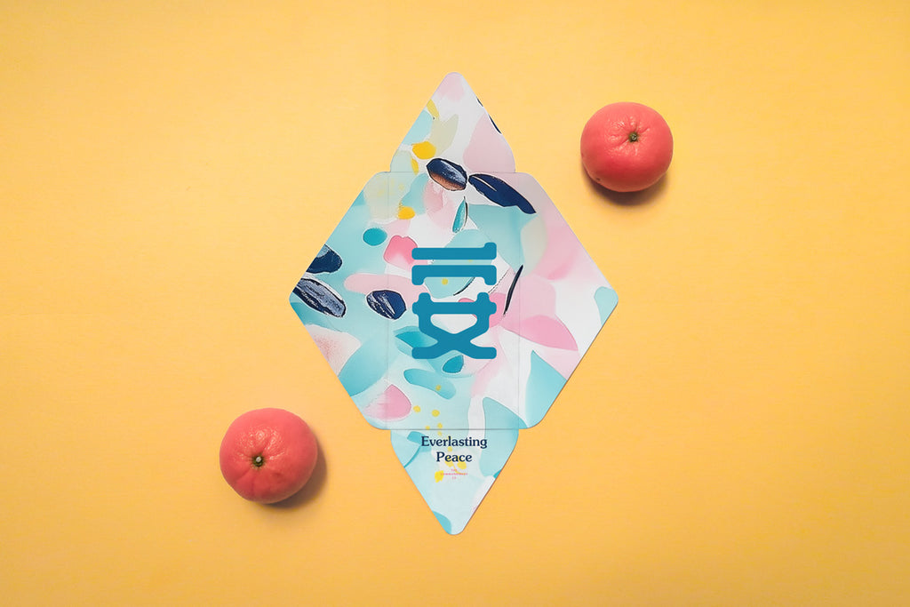 Chinese New Year red packet with 'Everlasting Peace' theme, featuring abstract pastel patterns and a bold teal Chinese character, placed alongside tangerines on an orange background.