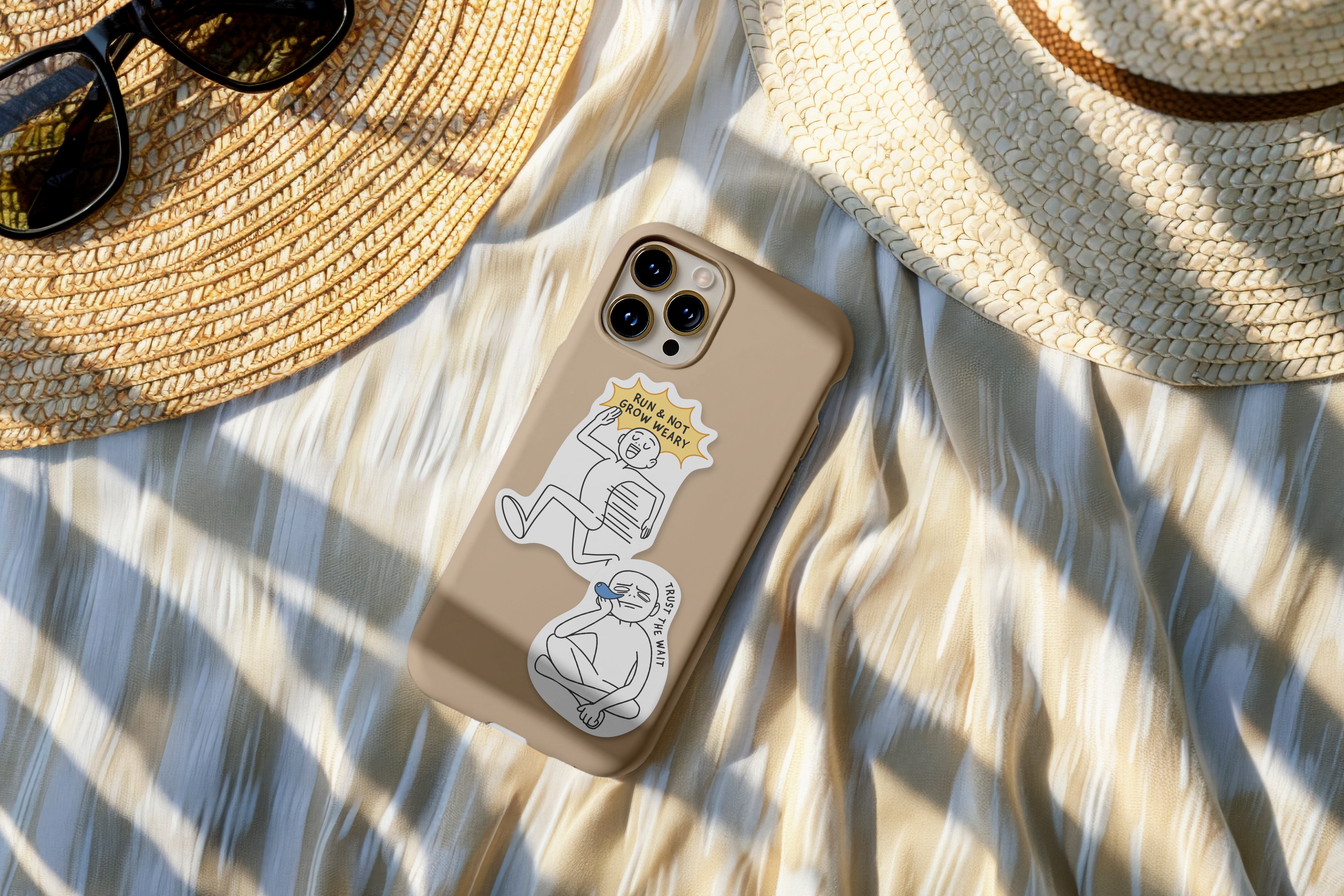 Phone case decorated with Everyday Believer stickers featuring Christian messages like "Run & Not Grow Weary" and "Trust the Wait," alongside a sun hat and sunglasses, from The Commandment Co, Singapore.