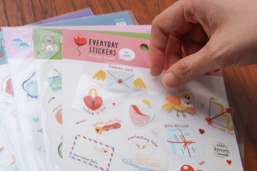 Close-up of everyday believer love themed Christian sticker sheet featuring cute icons like hearts, envelopes, dove, and phrases about love and faith