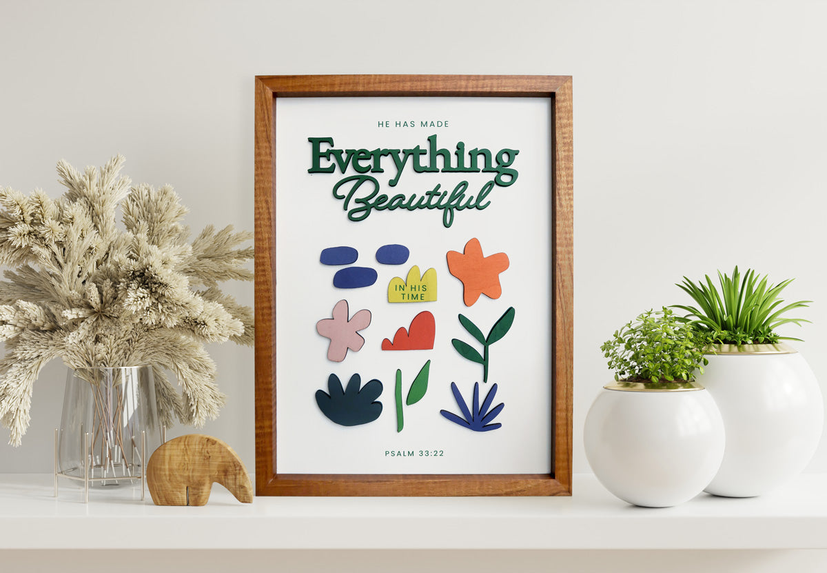 Everything Beautiful in His Time 3D wooden poster displayed on a shelf with plants.