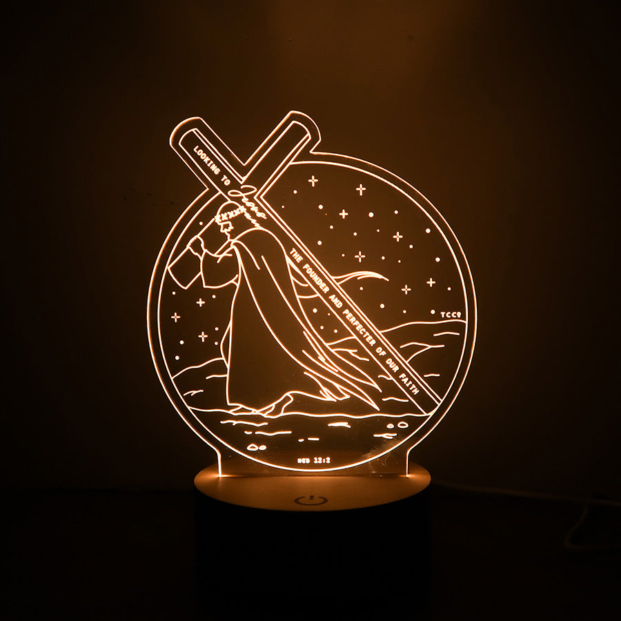 Christian LED lamp depicting Jesus carrying the cross with the verse from Hebrews 12:2: 'Looking to Jesus, the founder and perfecter of our faith.'