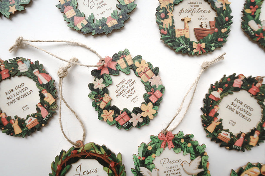 Close-up of faith-based Christmas wreath ornaments featuring Bible verses and festive decorations, perfect for meaningful holiday celebrations.