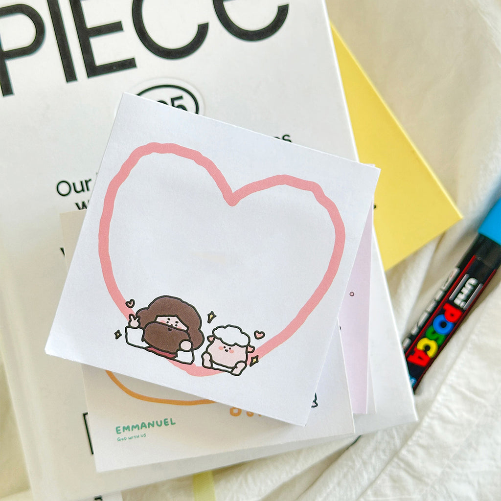 Christian-themed sticky note with a pink heart, a cute illustration of Jesus and a sheep, and handwritten Chinese text, used as inspirational stationery.