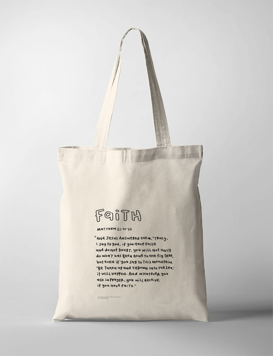 Faith Bible verse tote bag featuring Matthew 21:21-22 in a handwritten typography design on a natural canvas tote.