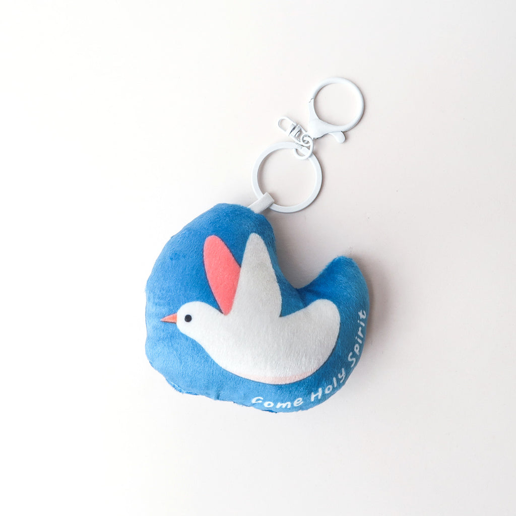 Blue heart-shaped plush keychain featuring a white dove with the phrase 'Come Holy Spirit,' symbolizing peace and faith