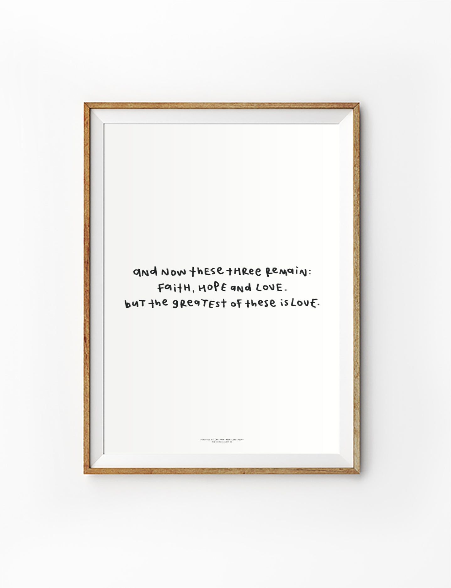 Faith Hope Love Bible verse poster featuring 1 Corinthians 13:13 in a simple handwritten style, displayed in a framed wall art mockup.