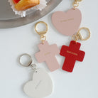 Faith-inspired keychains featuring cross and heart designs with engraved messages like 'God is love,' 'Peace,' and 'Hallelujah.' Perfect for gifting.