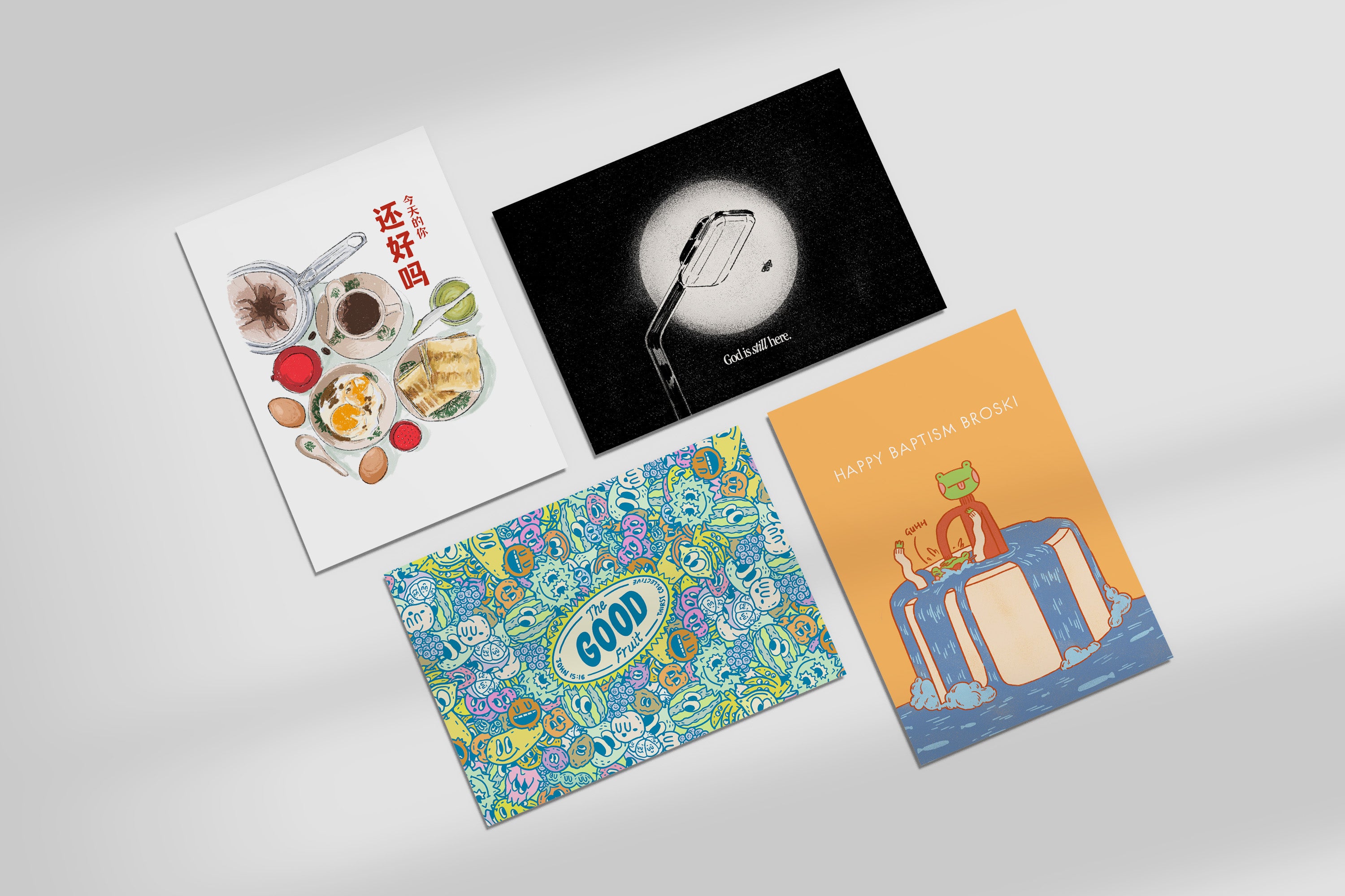 Flatlay of faith-inspired postcards including How Are You Today, God Is Still Here, The Good Fruit, and Happy Baptism Broski designs from The Commandment Co collaborations with Thir.st and HHM.