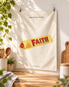 Faith Mountain Chocolate small wall tapestry clipped directly to a wall in a warm home interior.