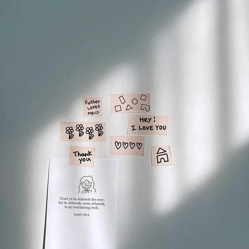Father Loves Me Christian washi tape with hand-drawn hearts, flowers, house illustrations and encouraging phrases displayed on a wall