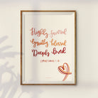 Inspirational wall art with the verse "Highly favored, Greatly blessed, Deeply loved" from Ephesians 1:6, showcasing soft, gradient lettering and a minimalist heart illustration, framed for a modern, spiritual touch.