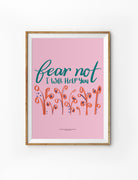 Pink Christian poster with hand-lettered words ‘Fear Not, I Will Help You’ and floral illustrations, inspired by Isaiah 41:13.
