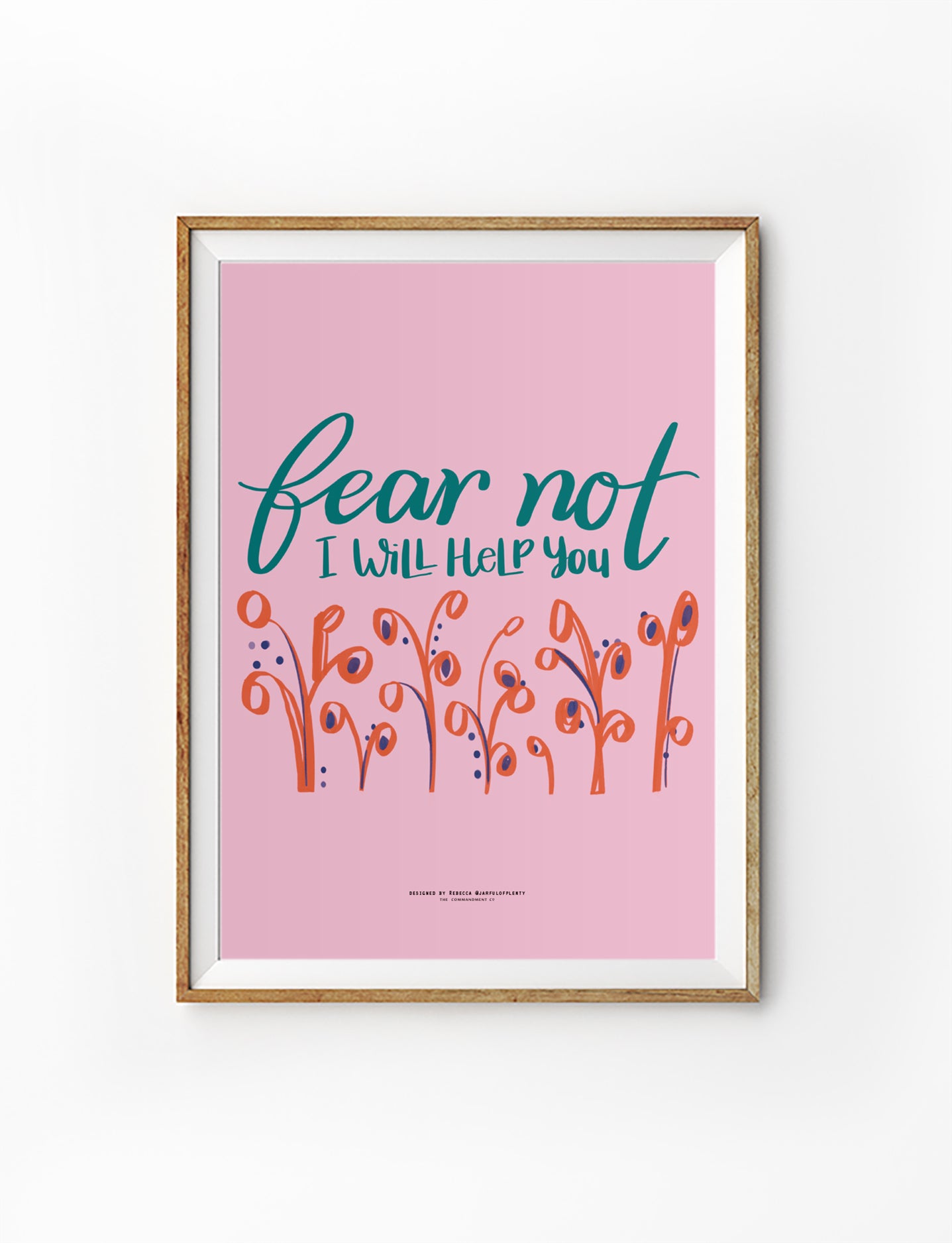 Pink Christian poster with hand-lettered words ‘Fear Not, I Will Help You’ and floral illustrations, inspired by Isaiah 41:13.