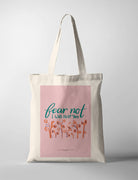 Pink Christian tote bag with hand lettering ‘Fear Not, I Will Help You’ and floral design inspired by Isaiah 41:13 promise of God’s help.