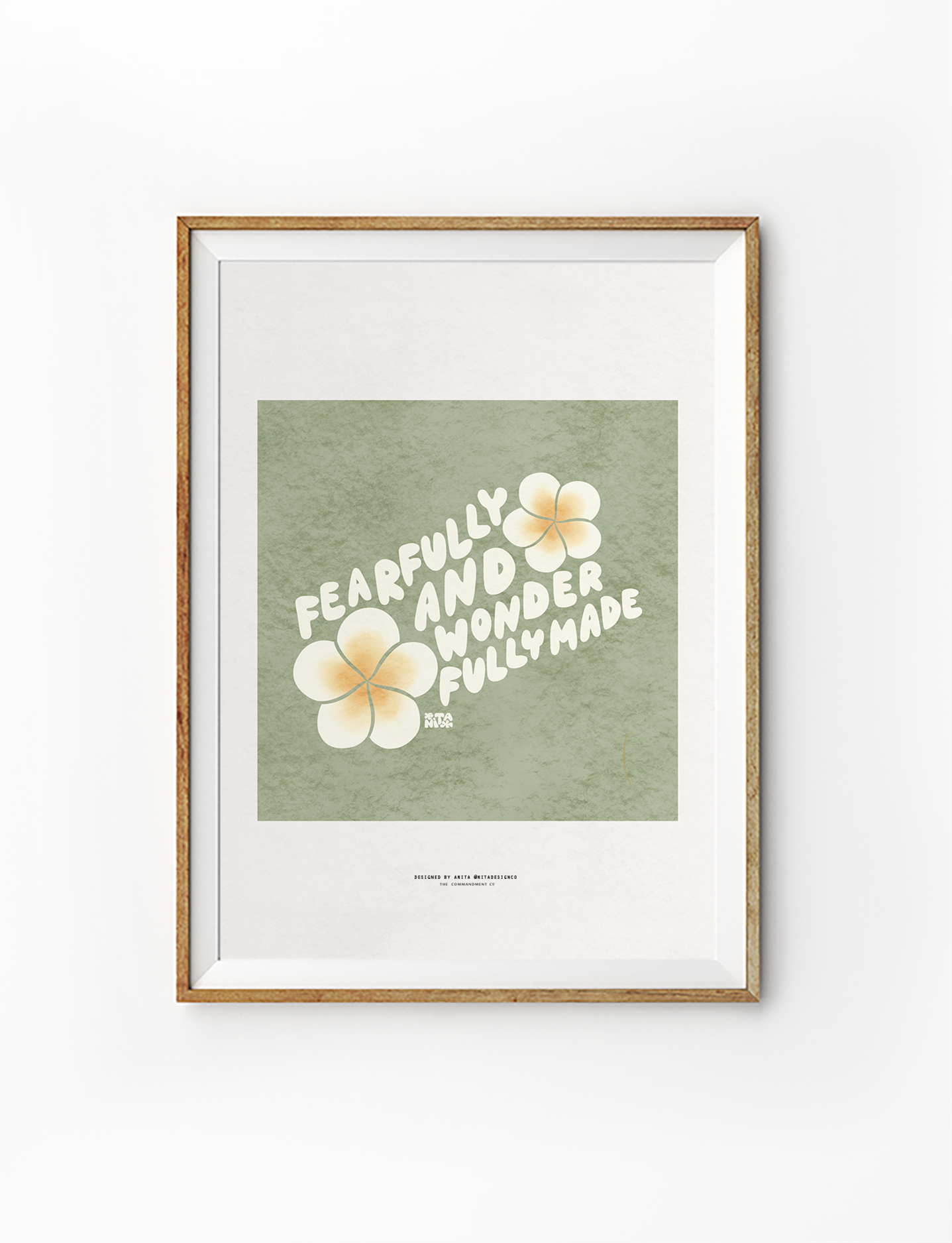 Encouraging "Fearfully and wonderfully made" poster in a wooden frame, featuring bold white lettering and soft yellow flowers on a green background, celebrating Christian identity and simple happiness.