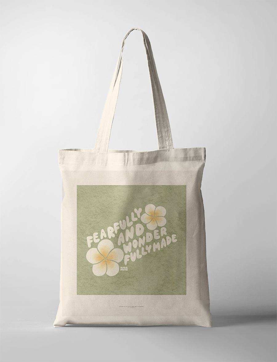 Encouraging "Fearfully and wonderfully made" tote bag, featuring bold white lettering and soft yellow flowers on a green background, celebrating Christian identity and simple happiness.