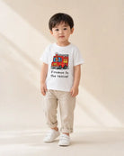 Young child wearing the white Firemen to the Rescue fire engine kids’ T-shirt