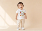 Smiling toddler wearing the white Fruit of the Spirit Party Christian kids’ T-shirt