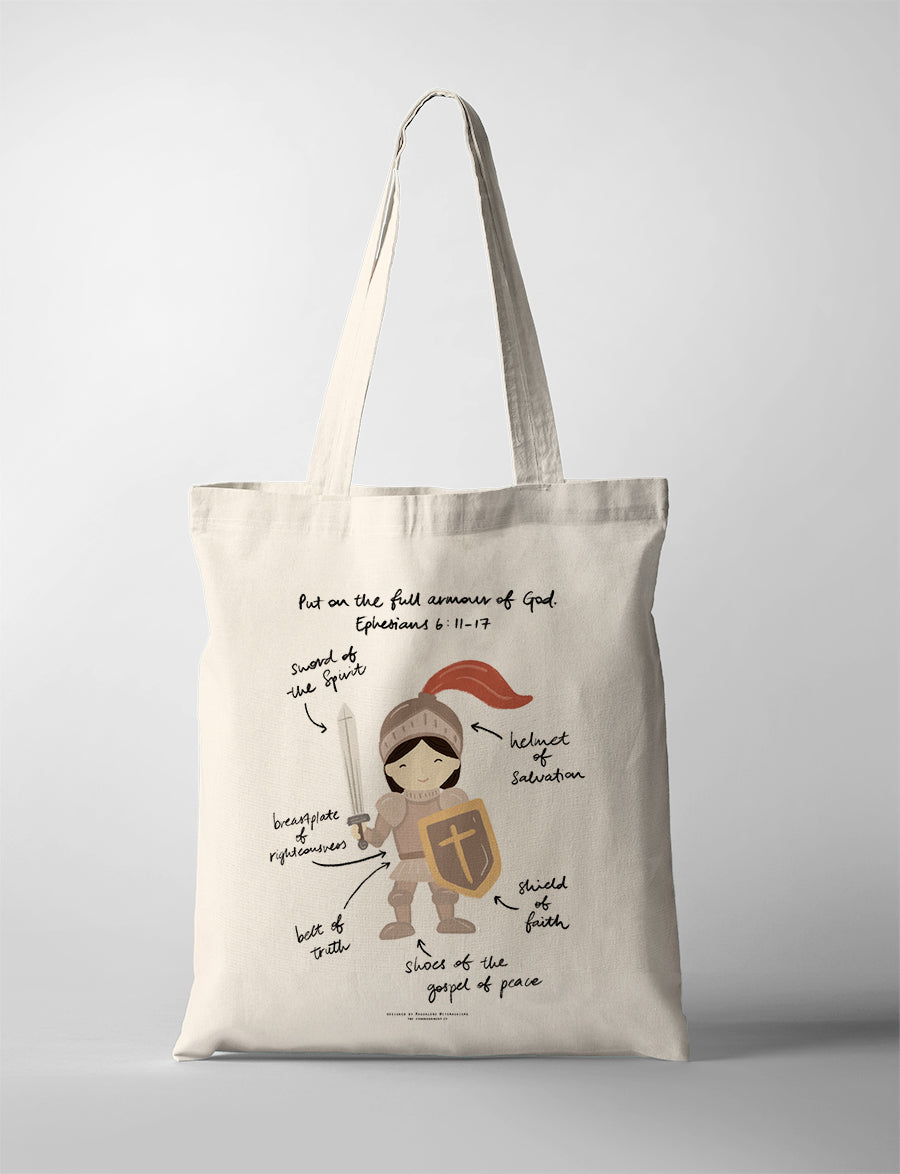Christian kids tote bag featuring a girl in the full armour of God with labelled pieces from Ephesians 6:11–17, including the sword of the Spirit, helmet of salvation, shield of faith, belt of truth, breastplate of righteousness, and shoes of the gospel of peace.