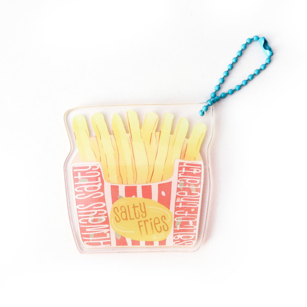 Playful keychain in the shape of a French fries container with the text ‘Salty Fries,’ featuring a striped red-and-yellow design and a blue chain.