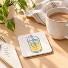 Glory of God Christian coaster with bubble tea illustration styled on a sunlit table.