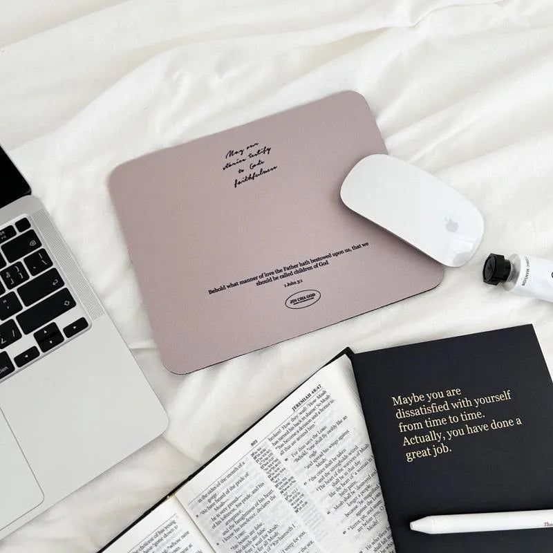 May Our Stories Testify to God’s Faithfulness Christian mouse pad featuring 1 John 3:1, styled with a laptop, Bible and notebook