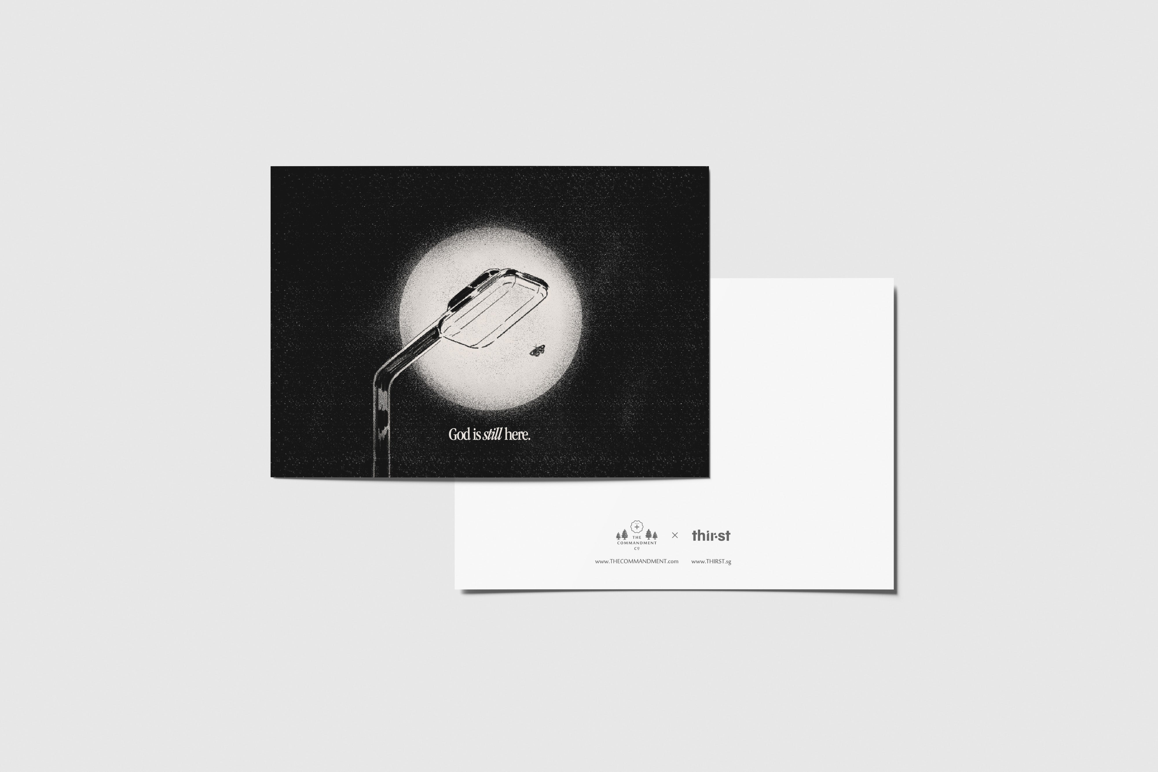 God Is Still Here postcard with black and white street lamp illustration, designed by Thir.st in collaboration with The Commandment Co.