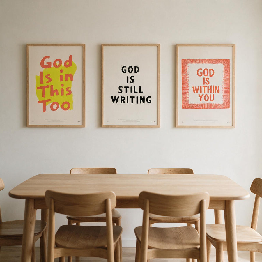 God Is Still Writing Christian poster displayed with coordinating faith prints above a dining table