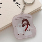 Close-up of the God Loves Us acrylic keychain featuring Jesus with a sheep and the message about being loved as God’s children