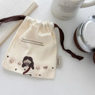 Cream Christian drawstring pouch featuring the message “God loves us not because of what we do but because we are His children”