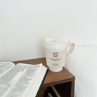 Eco-friendly reusable cup holder with "God loves you" and Jeremiah 31:3 Bible verse, perfect Christian gift for coffee lovers, shown on a bedside table with an open Bible.