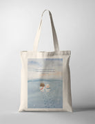 A heartwarming illustration of Jesus and a fluffy sheep walking together on a snowy path, symbolizing companionship and divine protection. The tote bag features the comforting Bible verse, 'I am with you and will watch over you wherever you go,' from Genesis 28:15.