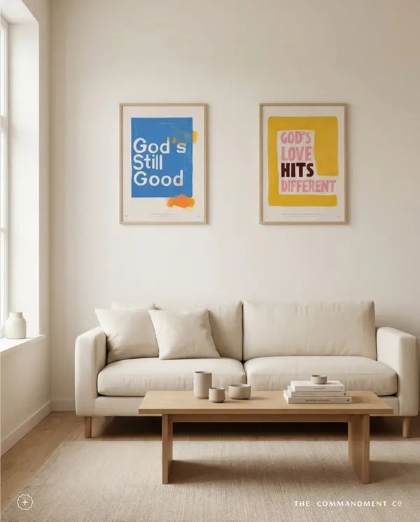 God’s Love Hits Different and God’s Still Good posters above a neutral sofa