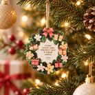 Good and Perfect Gift James 1:17 wooden Christmas ornament hanging on a warmly lit Christmas tree.