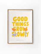 Good Things Grow Slowly Christian poster with yellow lettering and floral illustrations