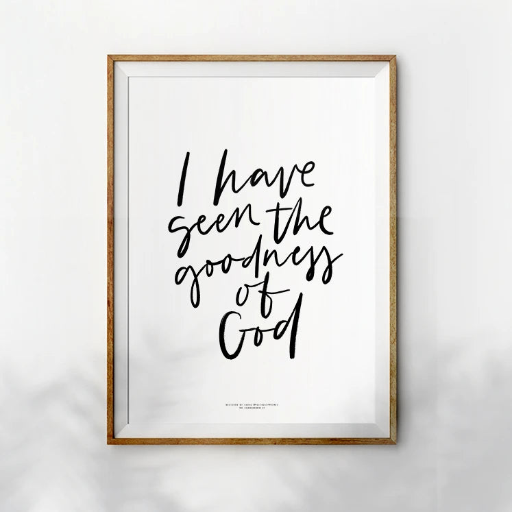 Minimalistic wall art featuring the words 'I have seen the goodness of God' in bold black calligraphy, displayed within a simple wooden frame against a white backdrop.