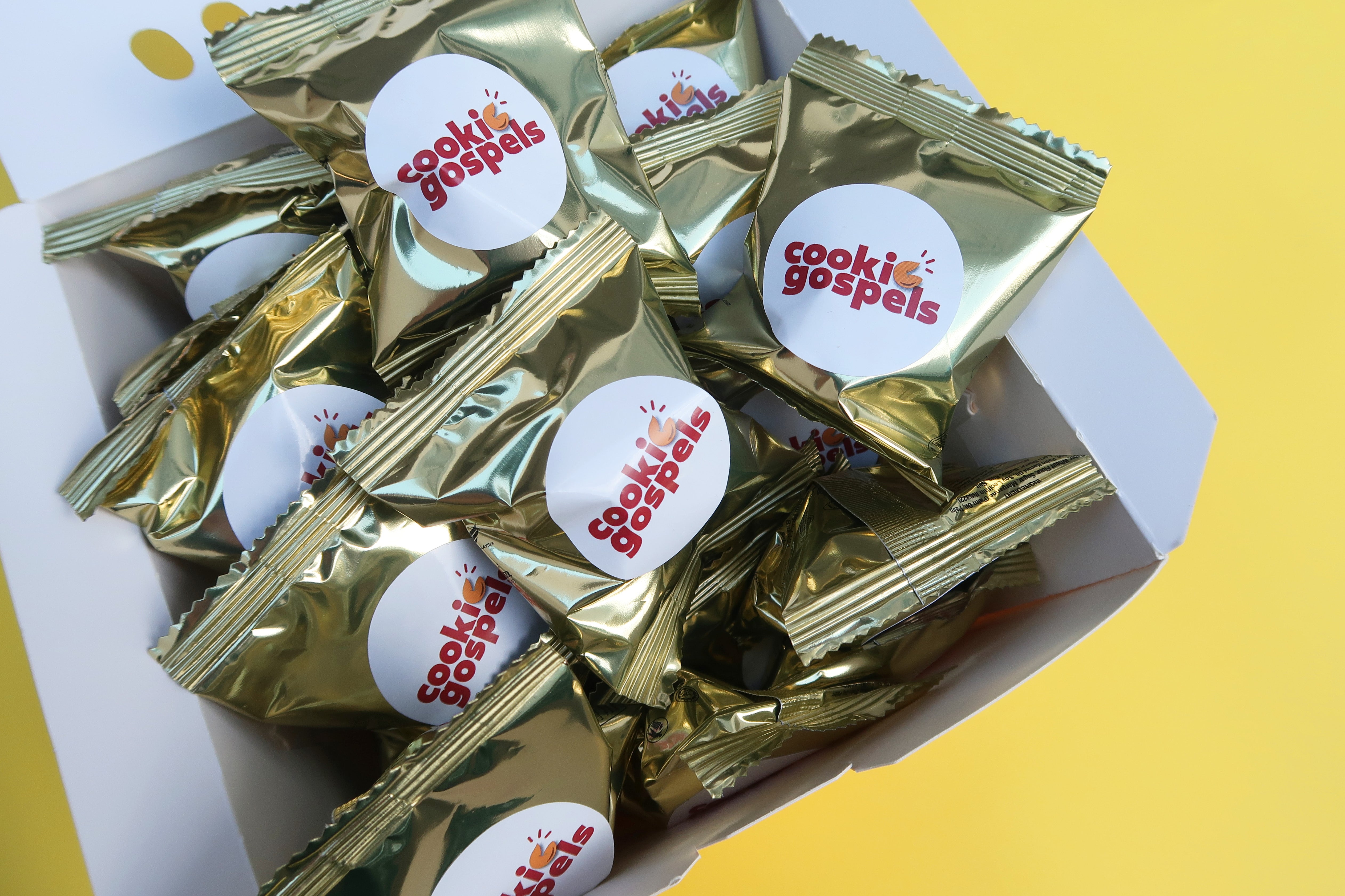 Box of Gospel Cookies filled with individually wrapped gold fortune cookies containing Bible verses