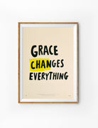 Grace Changes Everything Christian poster in a light wood frame
