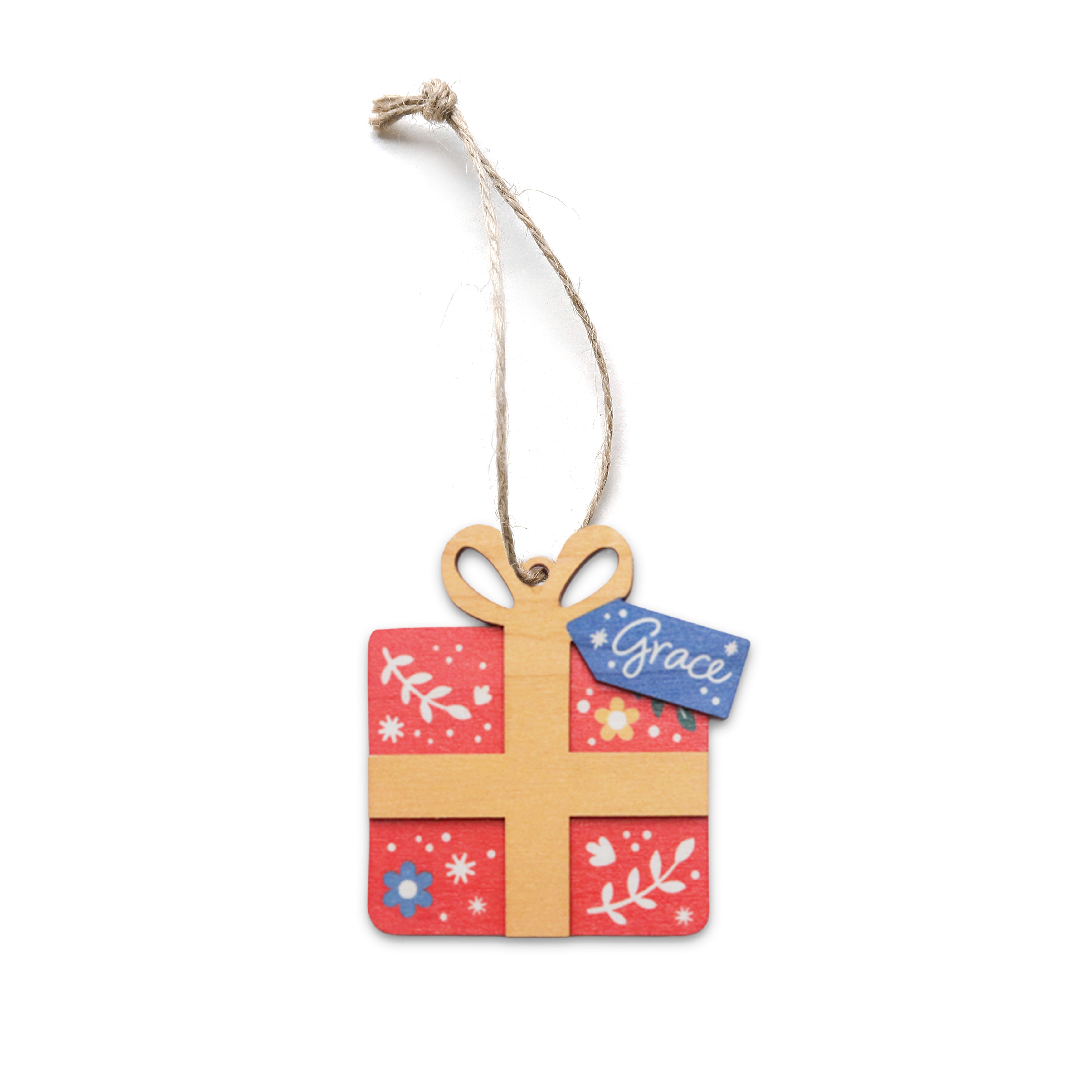 Red gift-shaped Christmas bauble with floral patterns and a blue tag that says ‘Grace’