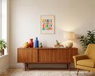Grace in Every Season Christian poster displayed above a wooden sideboard in a cosy living space