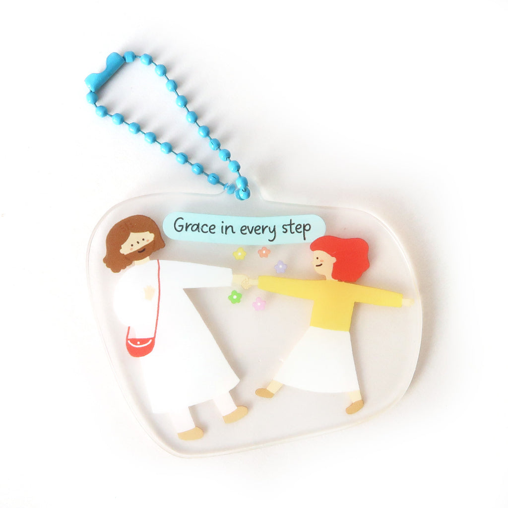 Christian keychain featuring the text 'Grace in every step,' with an illustration of Jesus and a child, designed as an inspirational faith-based accessory.