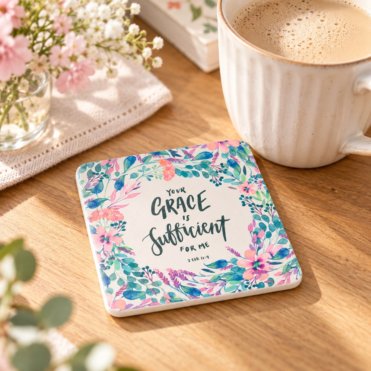Grace Is Sufficient 2 Corinthians 12:9 floral coaster beside a coffee cup on a wooden table
