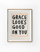Grace Looks Good on You Christian poster in a light wood frame