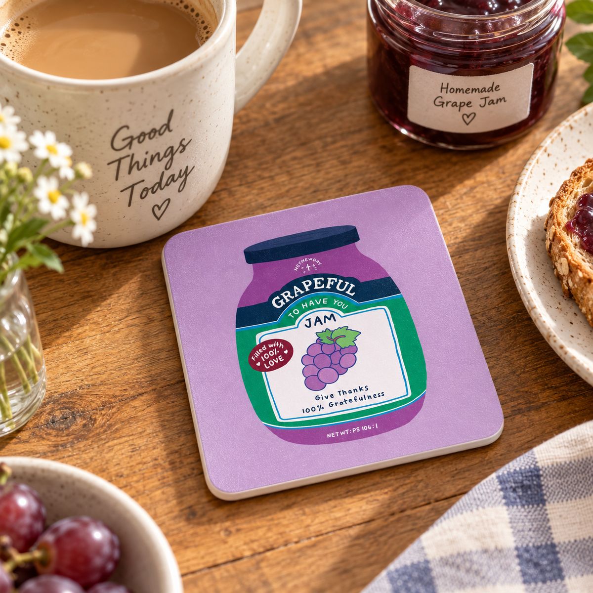 Grapeful Jam Christian coaster from the Love Supermarket collection styled beside coffee, grape jam and grapes on a wooden table.