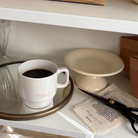 White mug with the words "Let's be grateful to everything" filled with coffee, placed on a tray beside craft supplies, inspiring gratitude and simple happiness as a thoughtful Christian gift from Jincha God